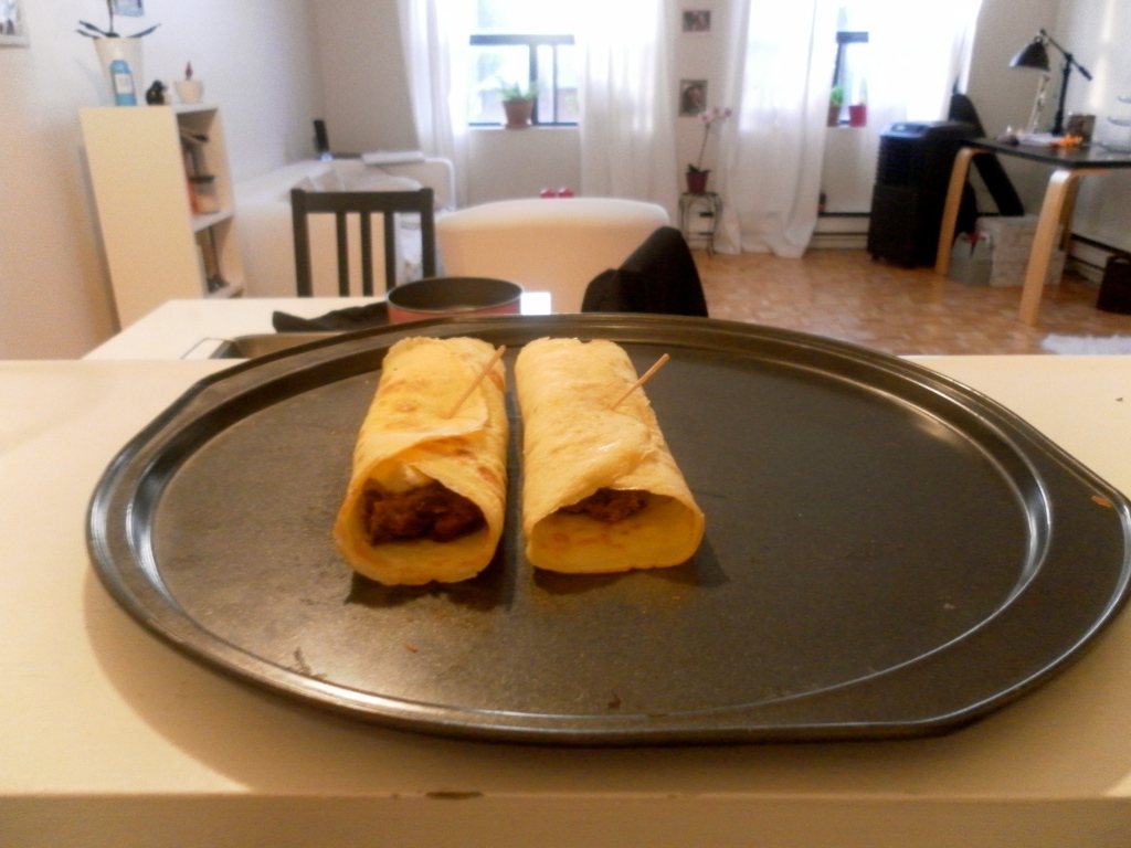 Baked crepes with refried beans and cheese