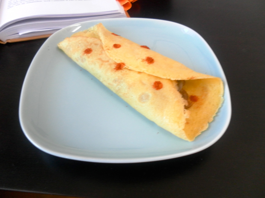 Baked crepes with refried beans and cheese