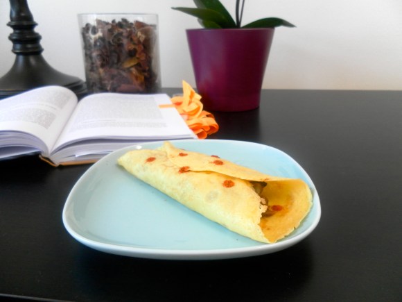 Baked crepes with refried beans and cheese