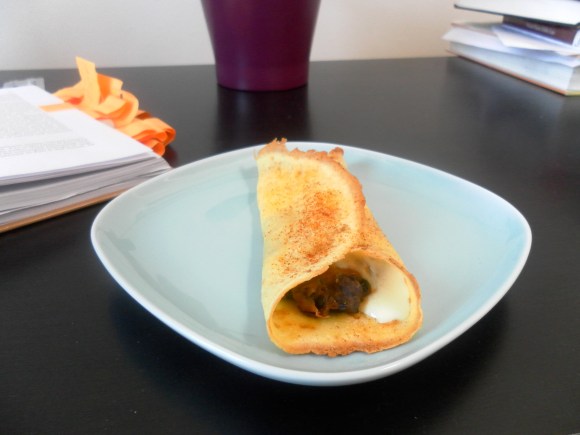 Baked crepes with refried beans and cheese